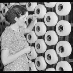 Millville, New Jersey - Textiles. Millville Manufacturing Co. (Woman standing at large spools of thread.) - NARA - 518675
