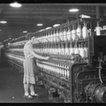Millville, New Jersey - Textiles. Millville Manufacturing Co. (Woman standing at long row of bobbins.) - NARA - 518676