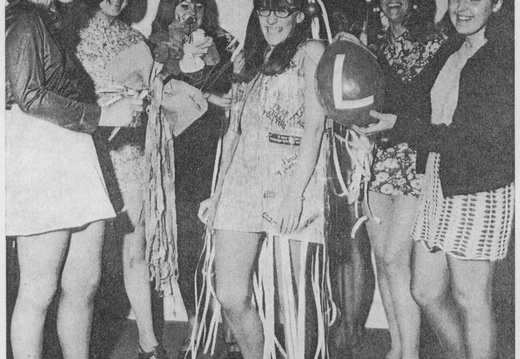A young woman named Anne Davis wears a punch tape dress at her “retirement party” as she leaves her job to get married
